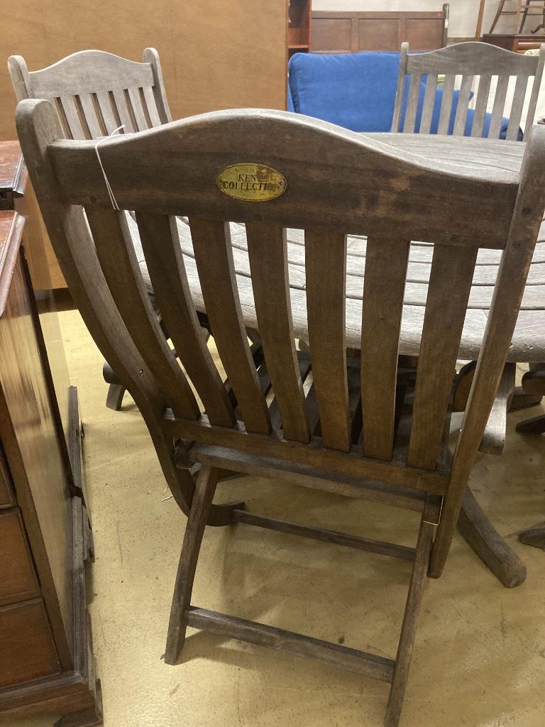 An Alexander Rose circular weathered teak garden table, diameter 144cm, height 71cm (no bolts) and four Kent collection folding chairs